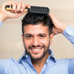 Happy man brushing full head of thick hair.