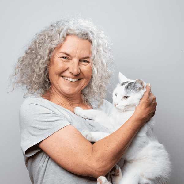 Woman smiling with her cat. 