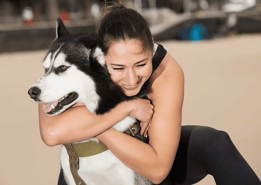 How do pets improve mental health? Woman hugging her dog. 