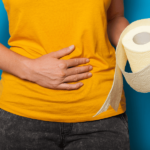 IBS relief vs Atrantil: person holding toilet paper.