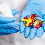 manufacturer holding different types of supplements