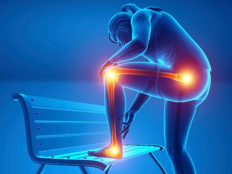 How to Put Out the Fire of Chronic Inflammation A blue-tinted illustration of a person holding their knee in pain, with their foot on a bench; knee, ankle, and hip joints are highlighted in orange.